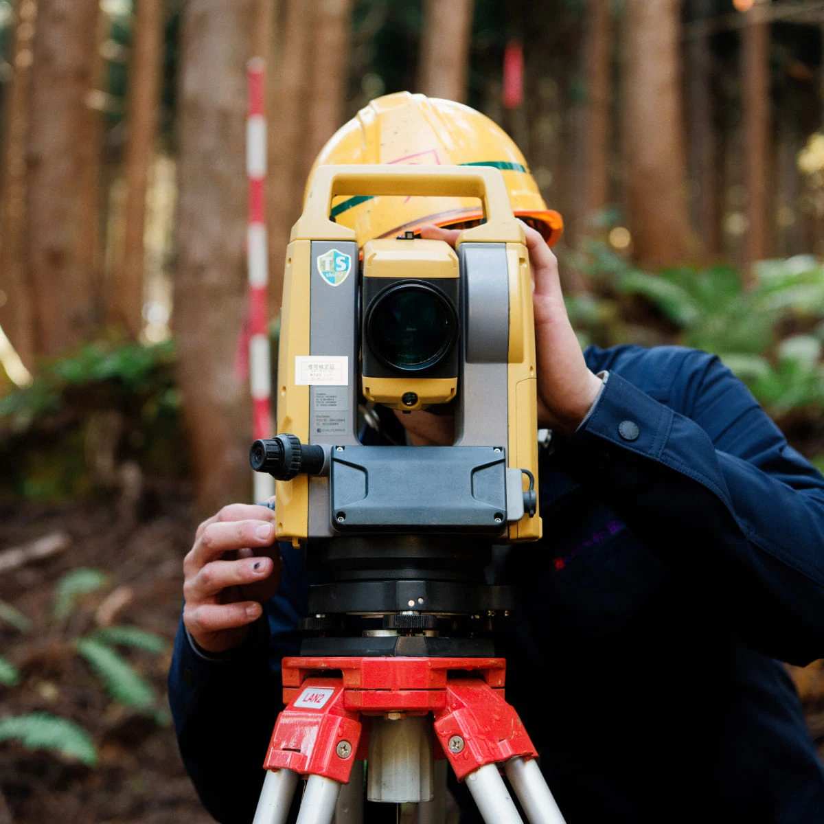 測量機を覗く社員